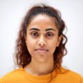 Close up horizontal front portrait of attractive young indian woman with serious expression on face